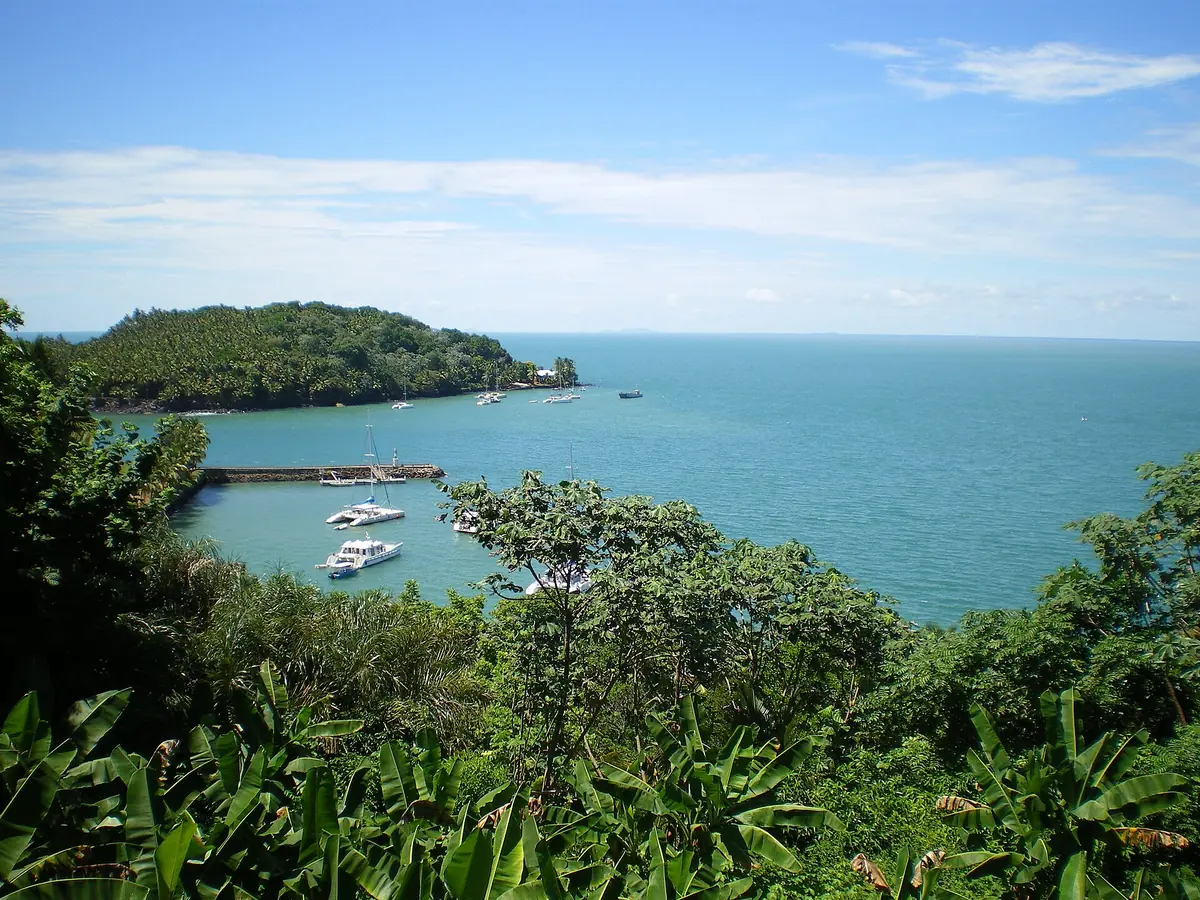 Boats moored in the harbor at Île Royale in the Salvation Islands
