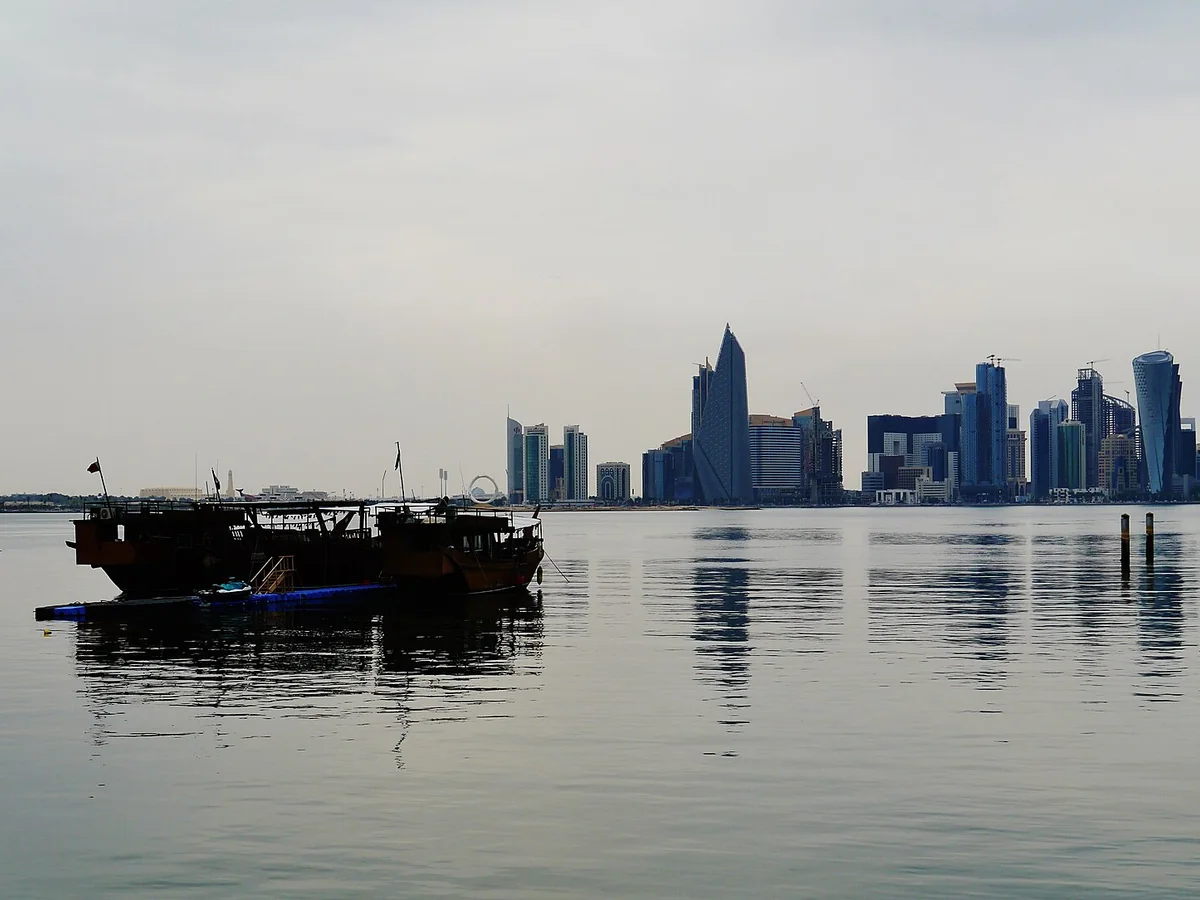 Traditional dhow boats on Doha Bay with the West Bay skyline beyond