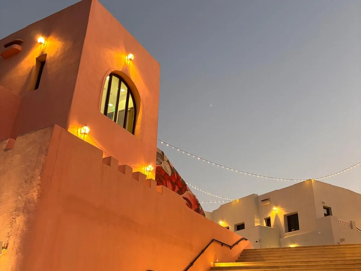 Illuminated steps and traditional-style buildings in Doha’s Mina District