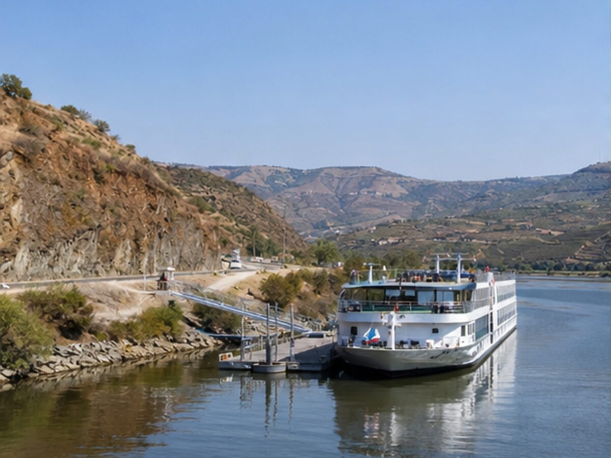 River cruise ship moored at a vineyard-lined quay on the Douro