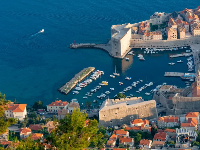 Boats and stone buildings around Dubrovnik Old Town harbor