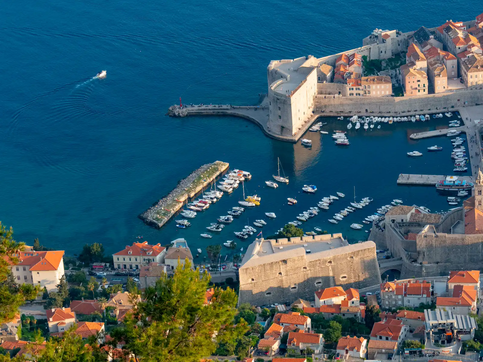 Boats and stone buildings around Dubrovnik Old Town harbor