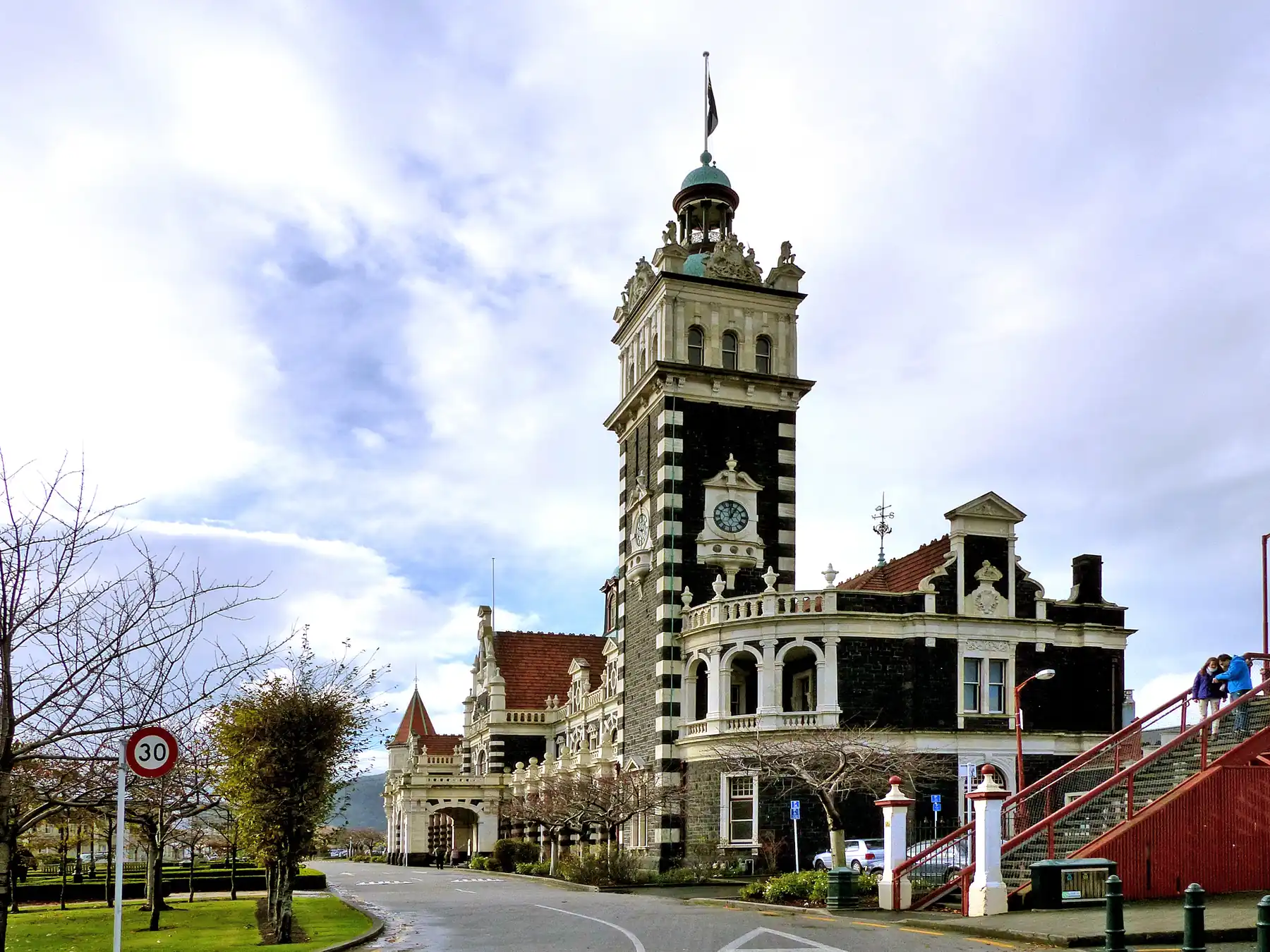 The ornate historic exterior of Dunedin Railway Station in New Zealand.