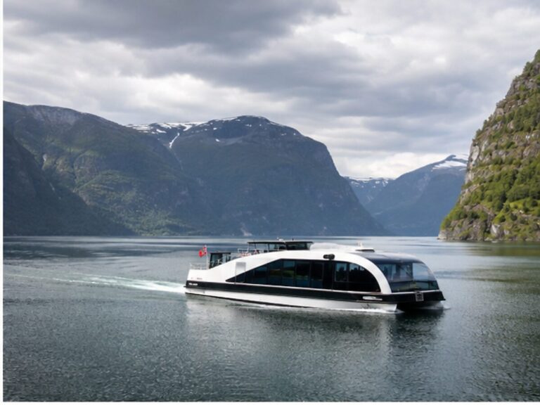 Compact electric sightseeing vessel crossing a quiet Norwegian fjord