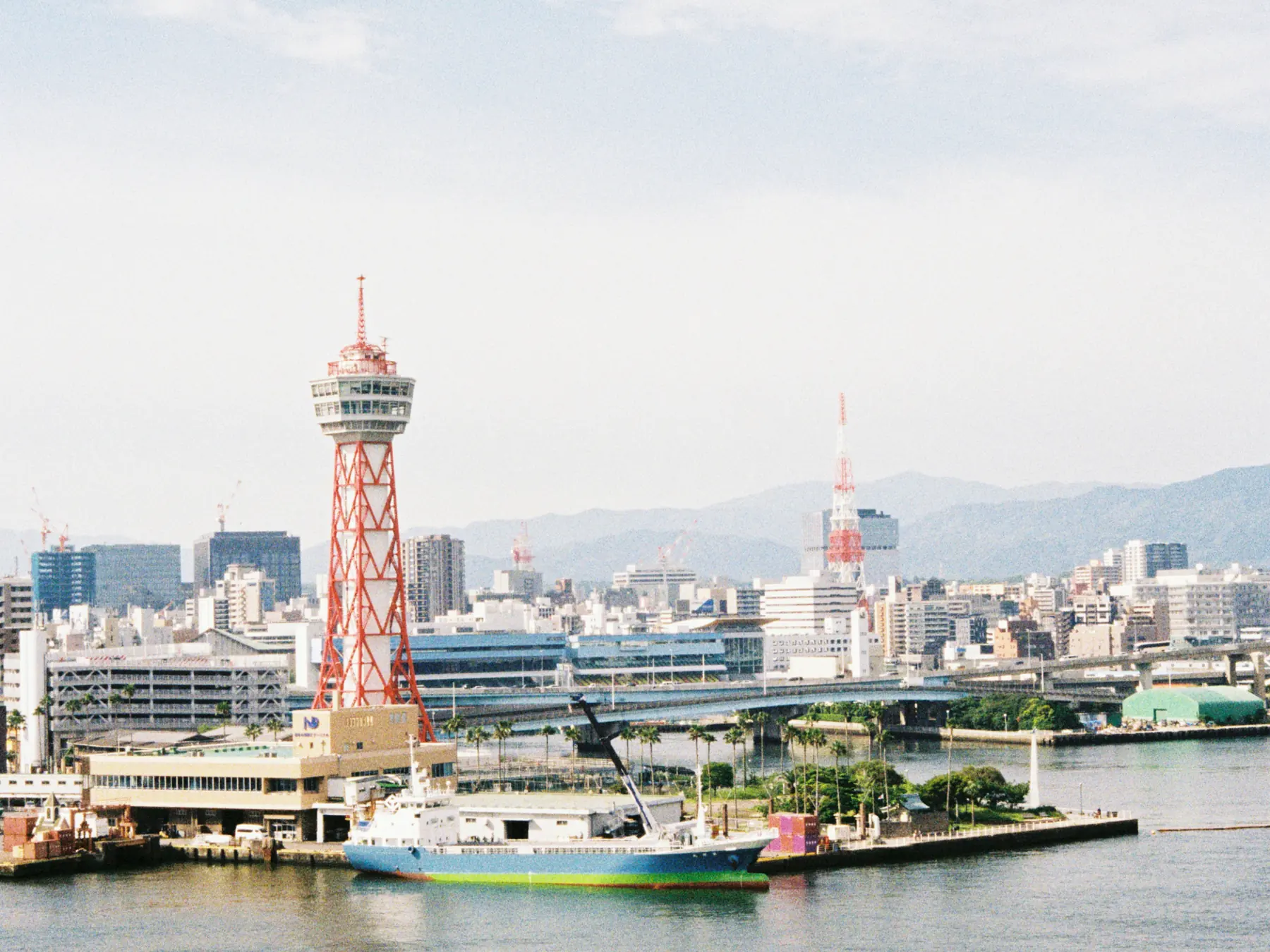 Hakata Port Tower and a ship along the Fukuoka waterfront.