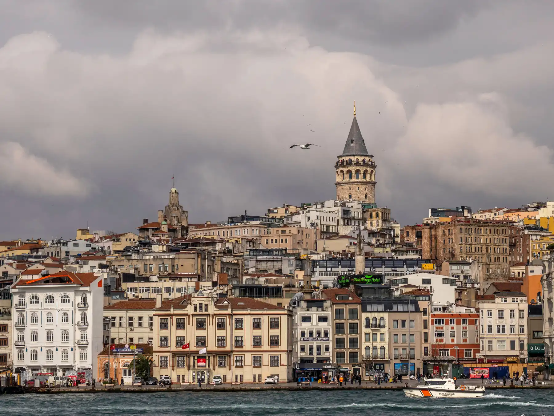 Galata Tower above Istanbul's waterfront buildings along the Bosphorus.