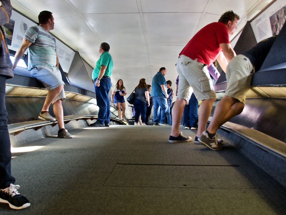 Visitors looking through windows inside the Gateway Arch observation deck