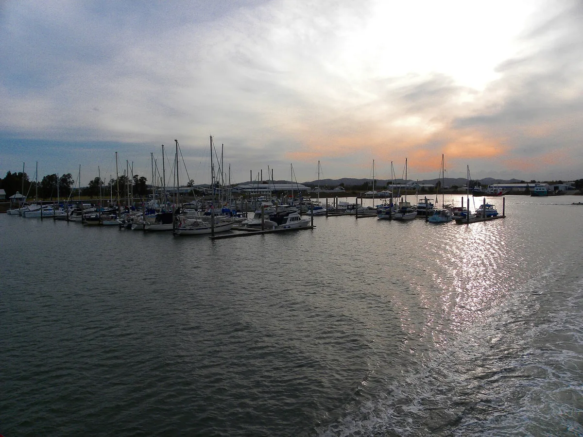 Boats moored in Gladstone Harbour at sunset