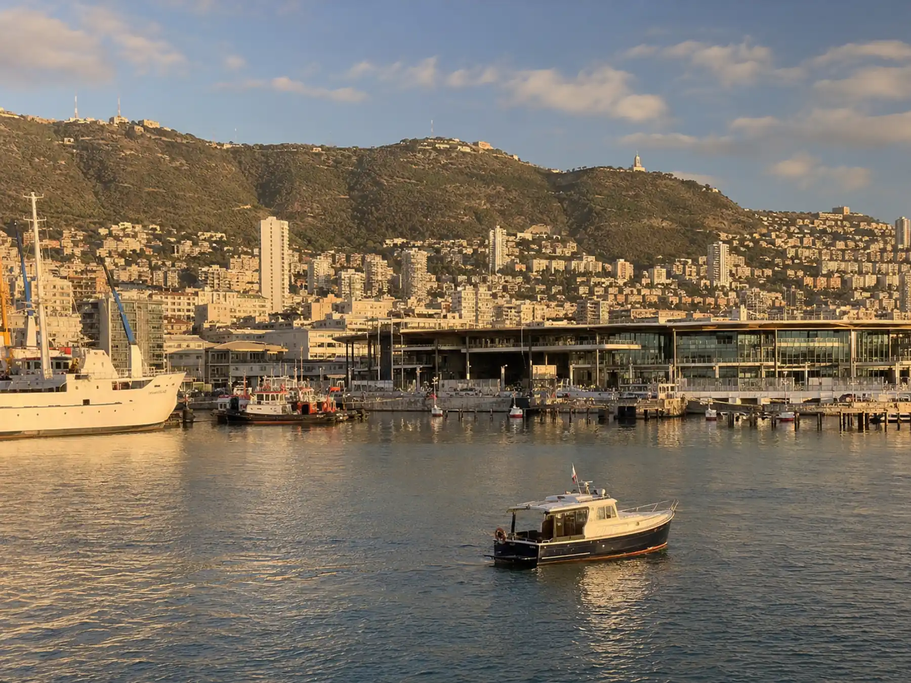 Haifa Bay harbor boats and waterfront beneath Mount Carmel.