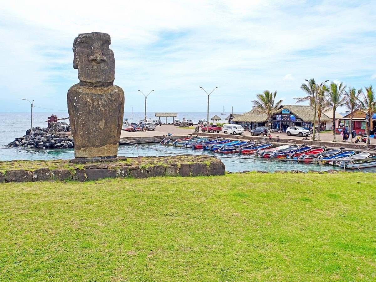 Moai and small boats beside Hanga Roa Otai harbor on Easter Island