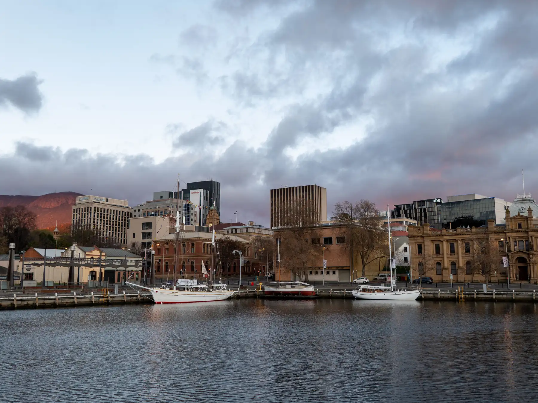 Boats and waterfront buildings in Hobart, Tasmania, in the early morning light.