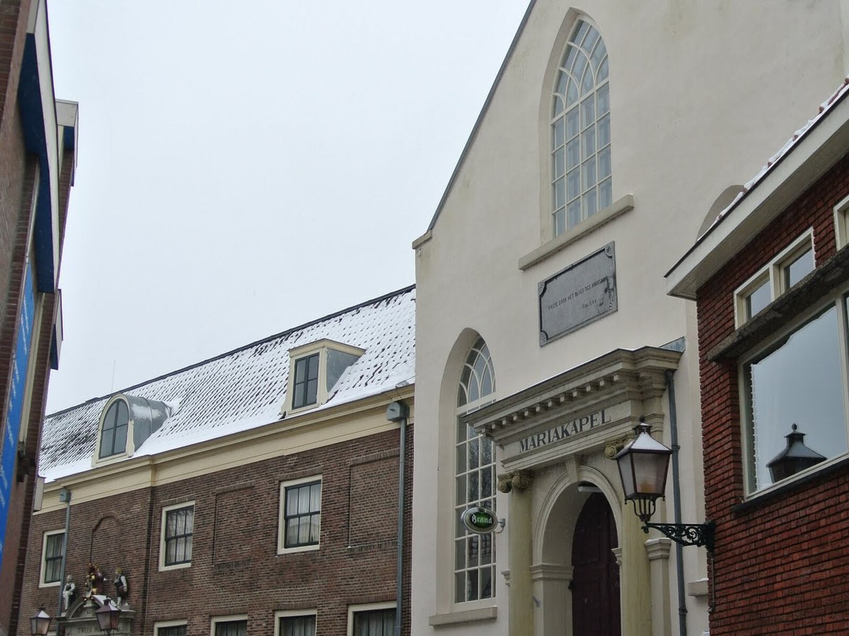 Old town street with historic brick facades in a North Holland harbor town