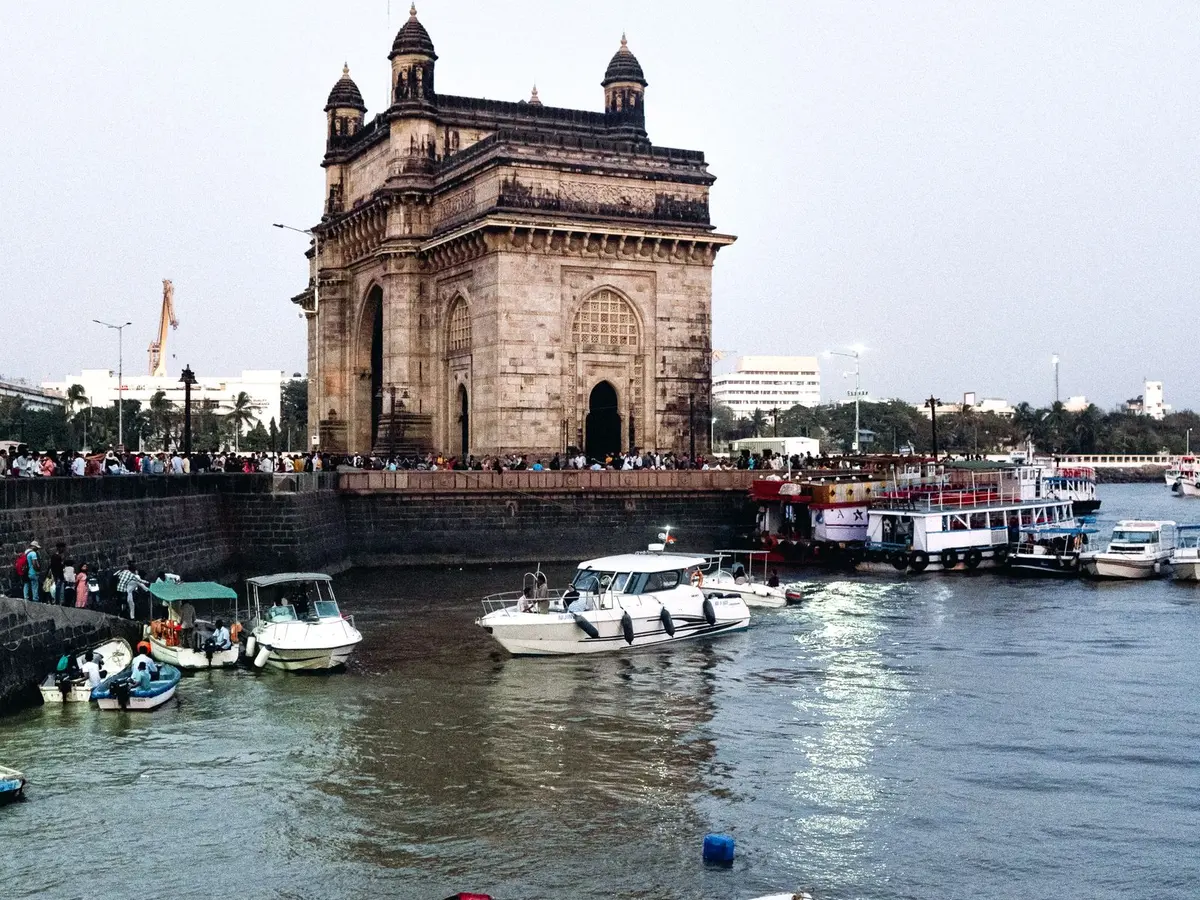 Gateway of India and boats along Mumbai harbor in India