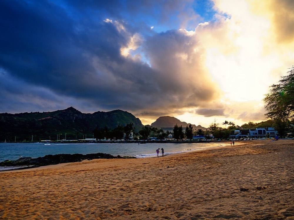 Kalapaki Beach and Nawiliwili Bay under dramatic clouds at sunset