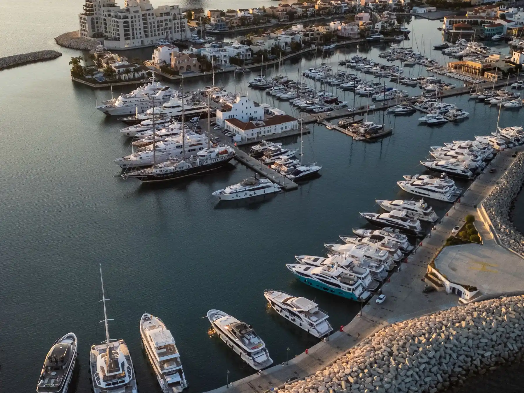 Boats moored in Limassol Marina as warm evening light falls across the waterfront.