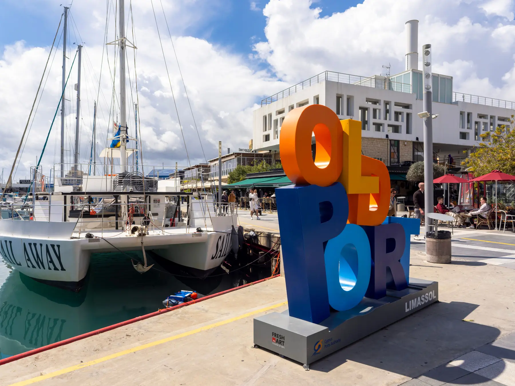 Yachts and modern buildings along the Limassol Marina waterfront.