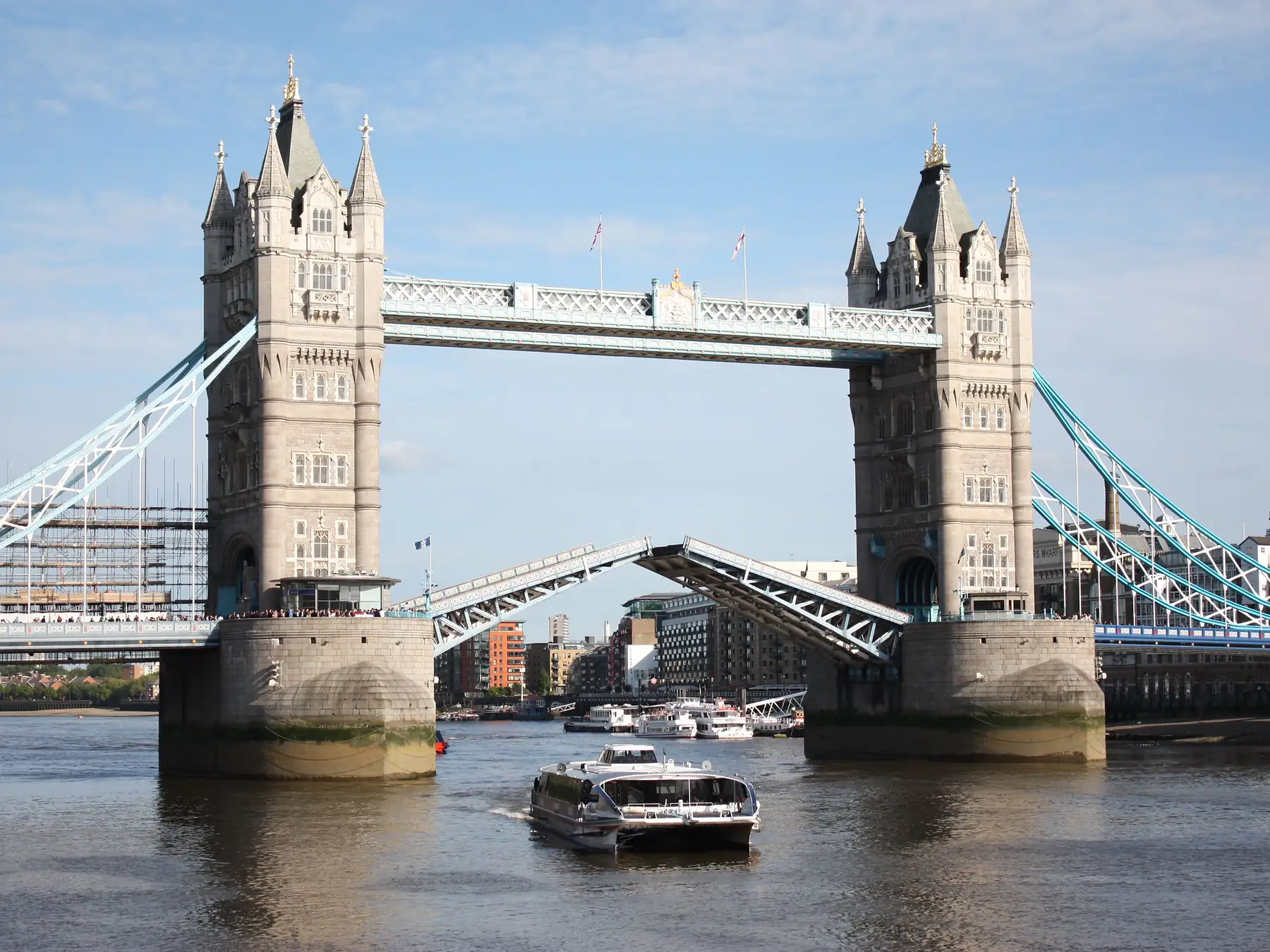 Tower Bridge raised for a boat traveling along the River Thames in London.