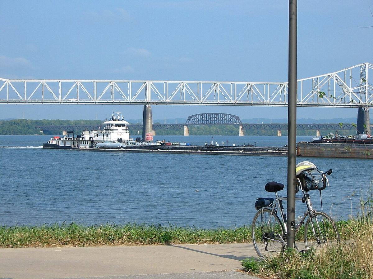 Towboat and barges on the Ohio River beneath bridges at Louisville