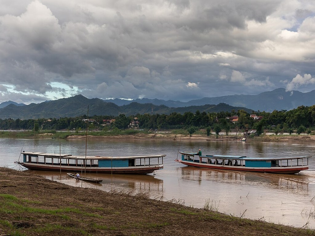 Boats on the Mekong River at Luang Prabang under afternoon clouds