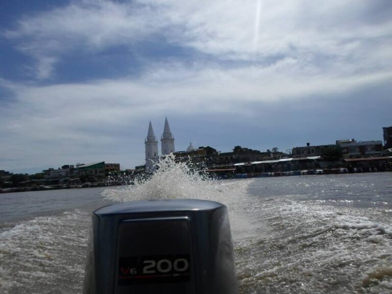 Magangué riverfront and cathedral seen from a boat on the Magdalena River