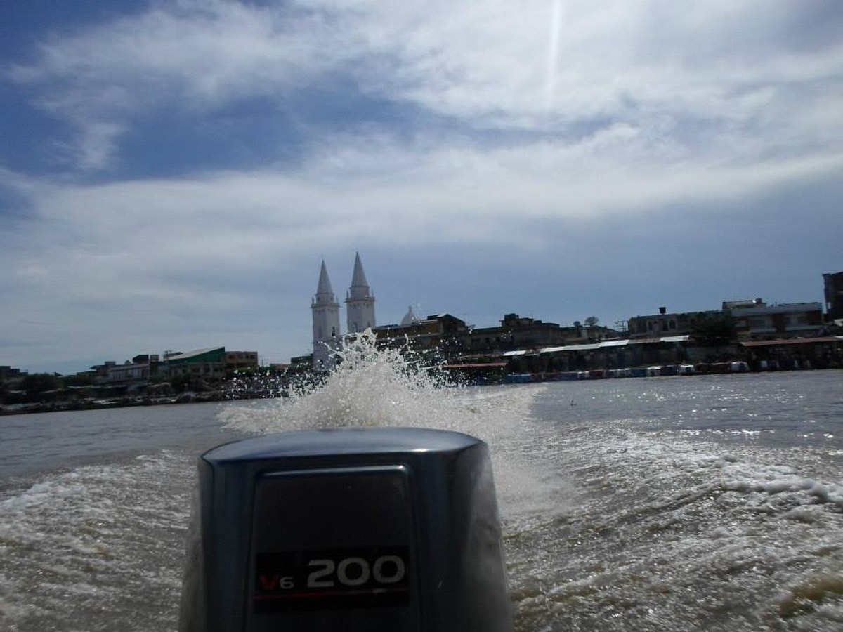 Magangué riverfront and cathedral seen from a boat on the Magdalena River