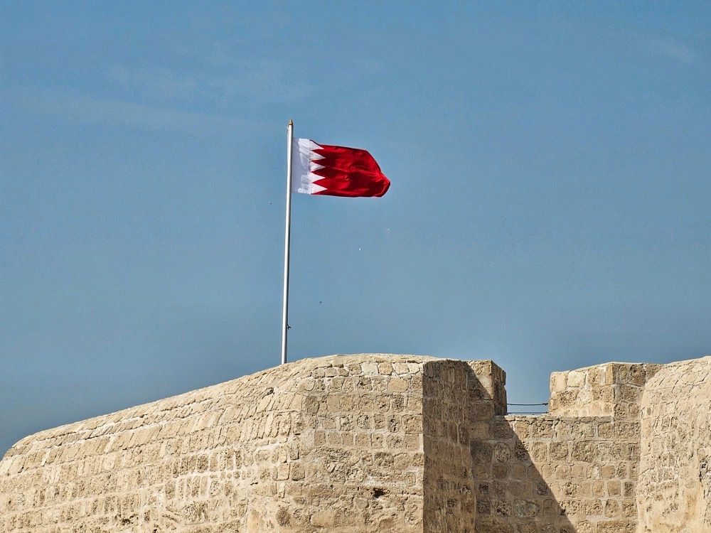 Bahrain flag flying above the stone walls of Qal'at al-Bahrain