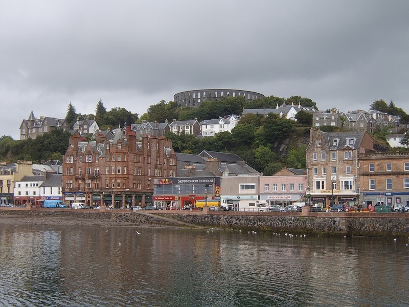 McCaig's Tower rising above the colorful waterfront buildings of Oban