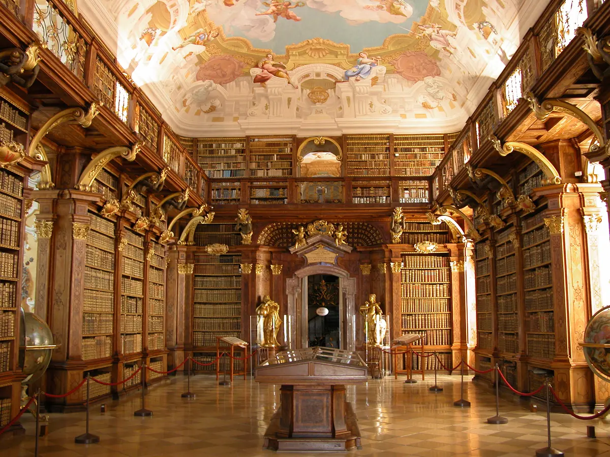 Historic library room with frescoed ceiling and bookcases at Melk Abbey