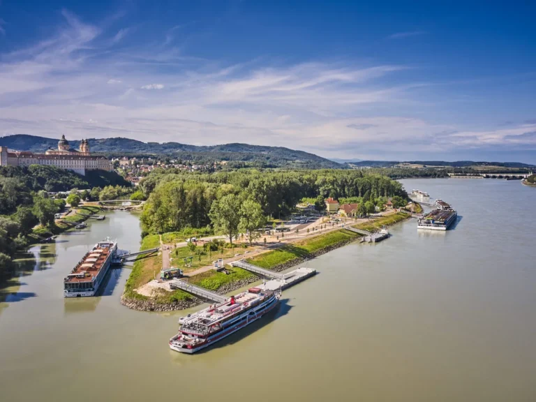River cruise ships at Melk landing stages below Melk Abbey on the Danube