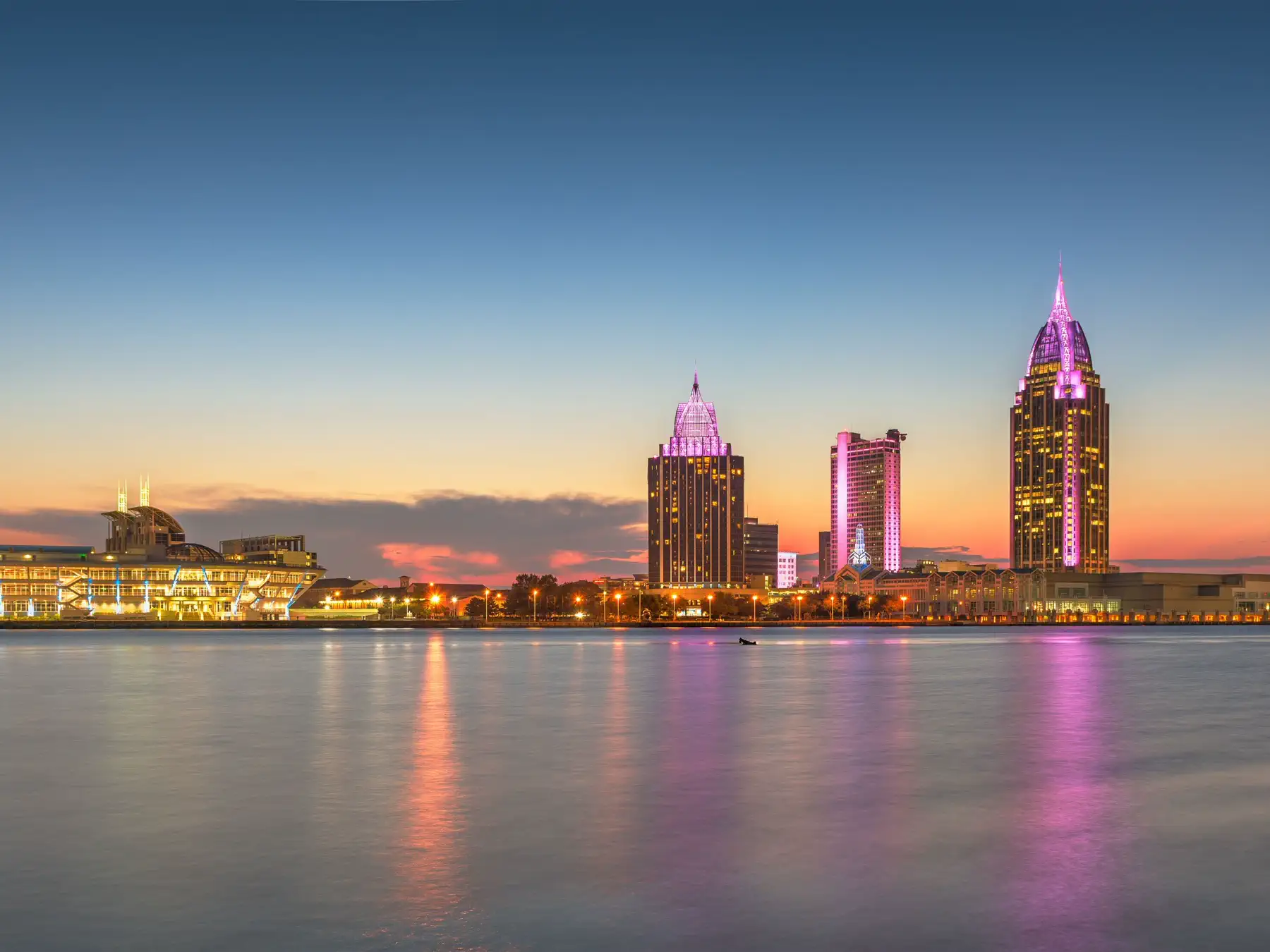 Downtown Mobile, Alabama skyline and waterfront at dusk