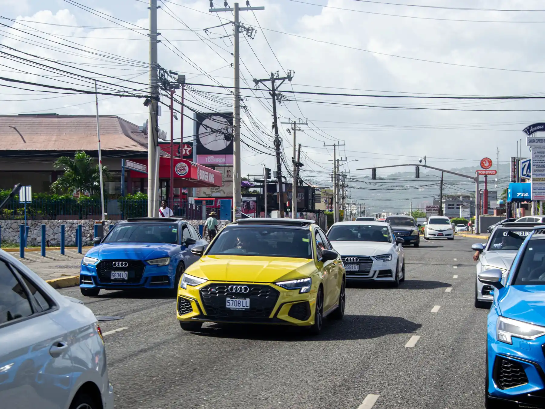Colorful urban street scene in Montego Bay, Jamaica under a clear tropical sky.