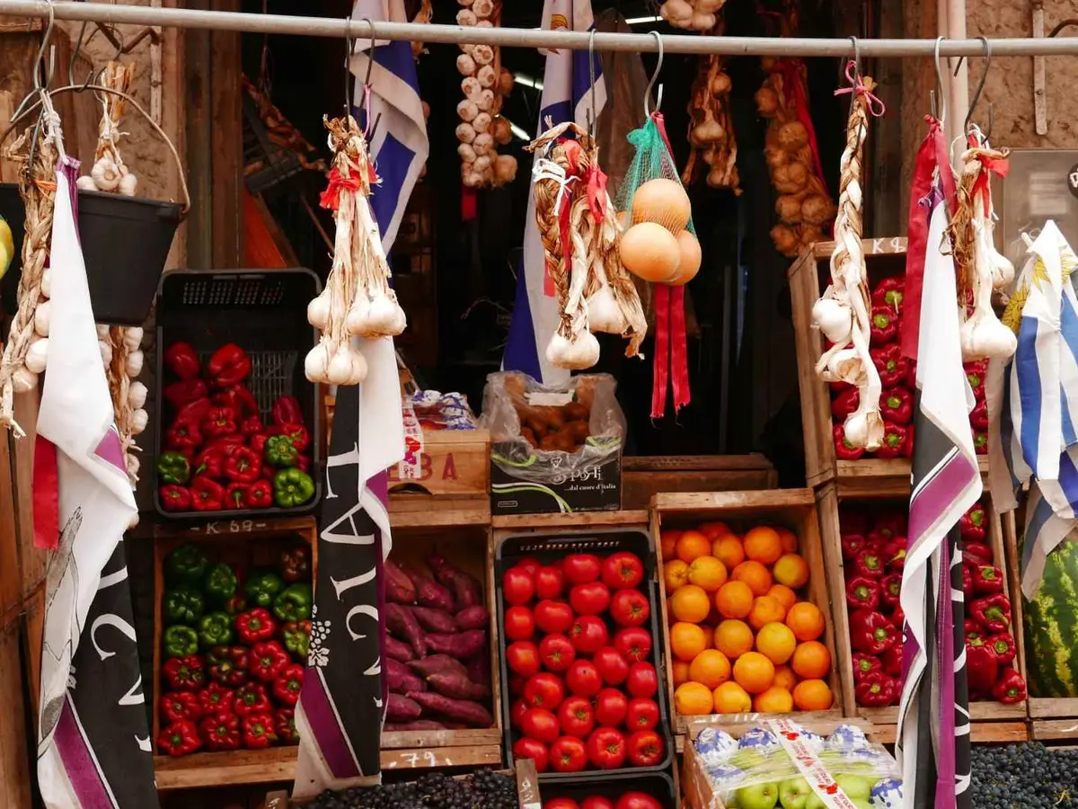 Colorful produce and hanging goods inside Mercado del Puerto in Montevideo