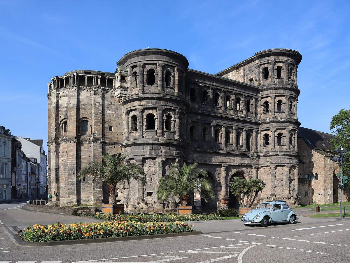 Porta Nigra Roman gate with a vintage car in Trier, Germany