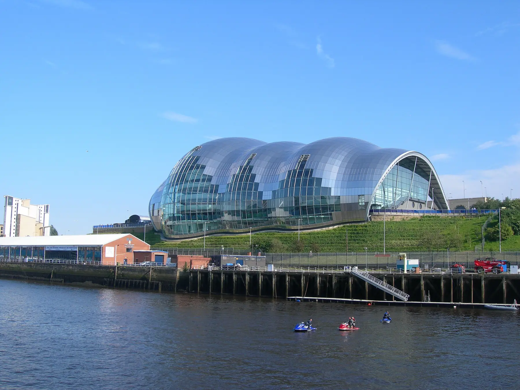 Sage Gateshead beside the River Tyne with kayakers on the water.
