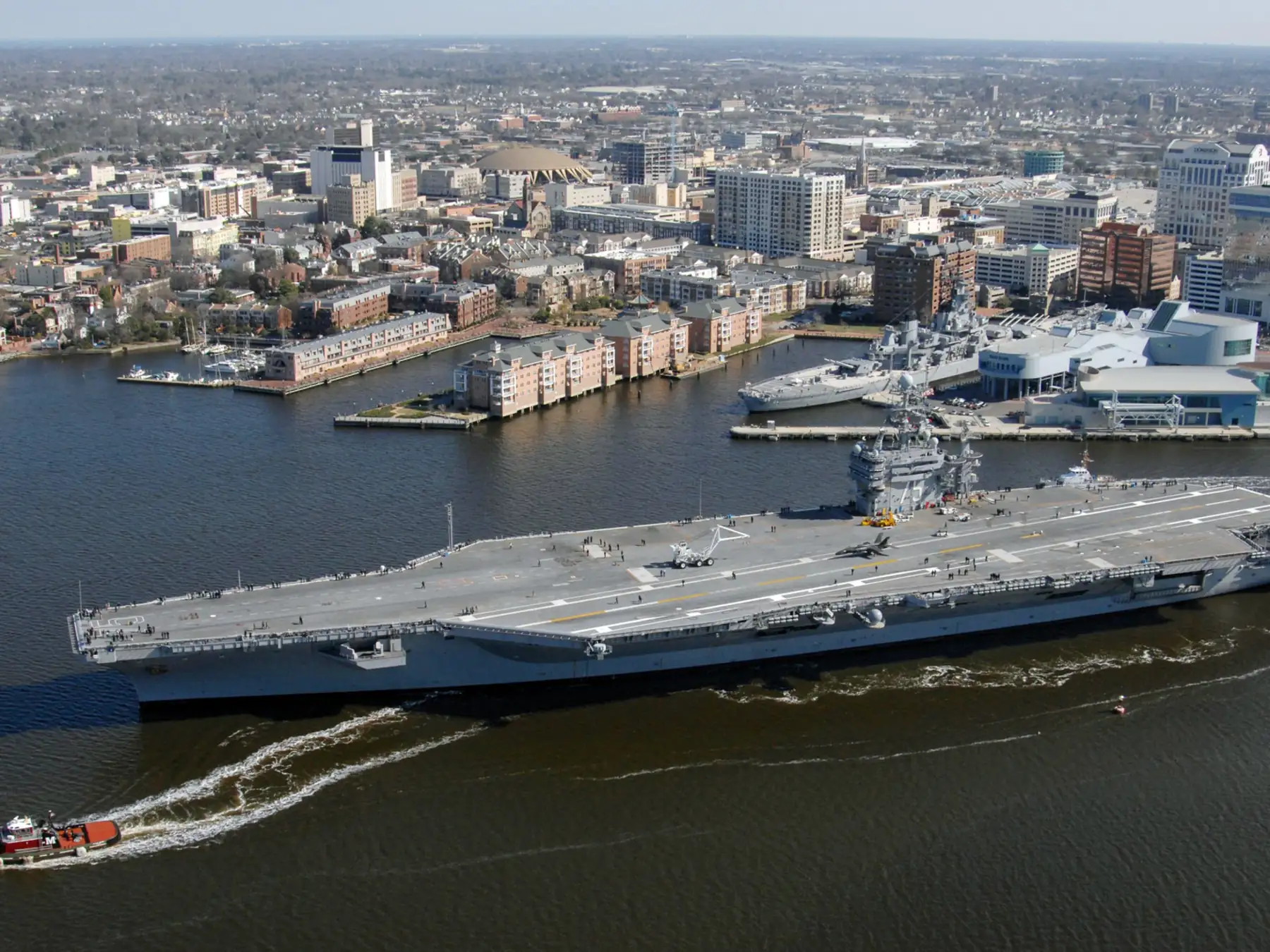 A naval ship passing the downtown Norfolk waterfront on the Elizabeth River.