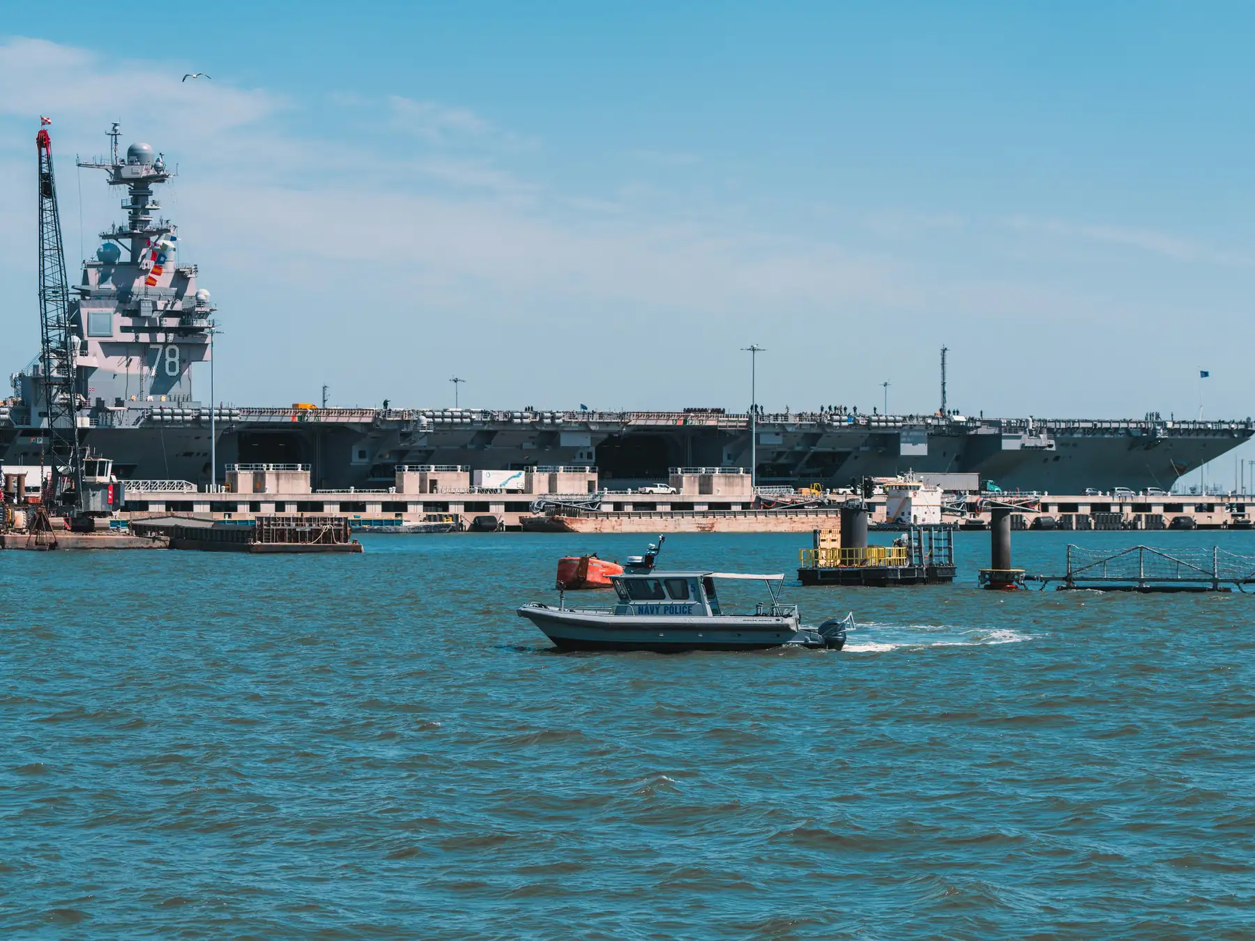 Naval vessels and waterfront buildings along the Elizabeth River in Norfolk, Virginia.