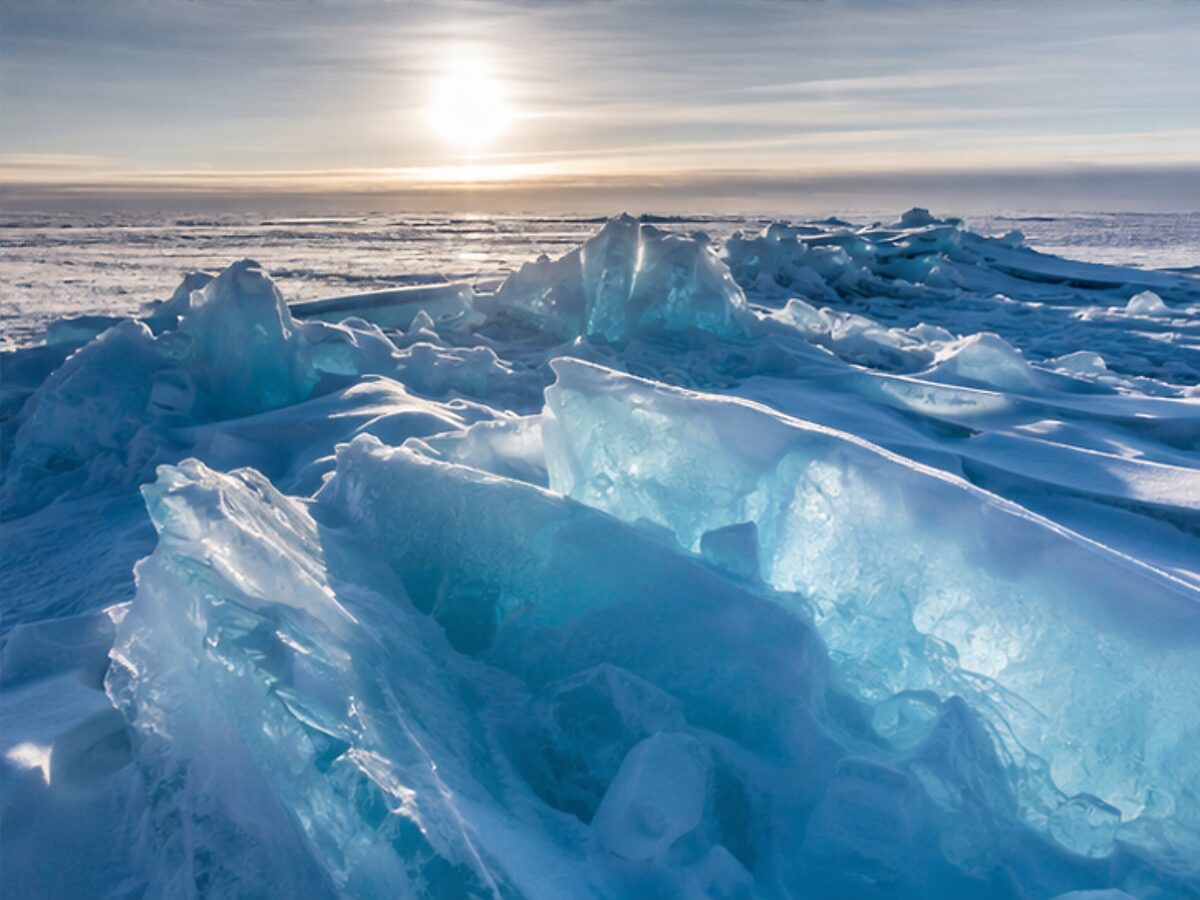 Blue pressure ridges and pack ice near the North Pole under low Arctic sunlight