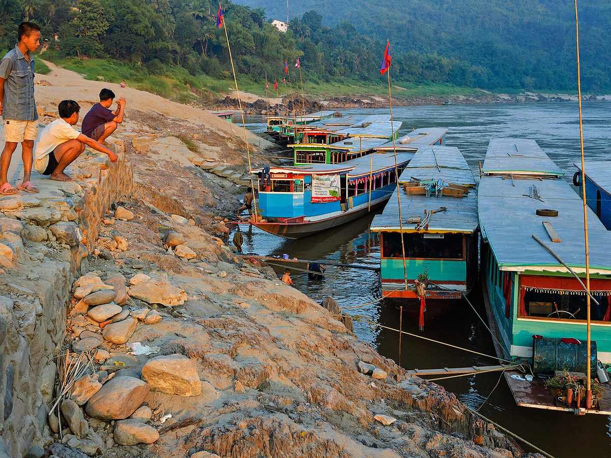 Pak Beng slow boats on the Mekong river bank at sunset Laos 23Nov2005 at Pak Beng, Laos