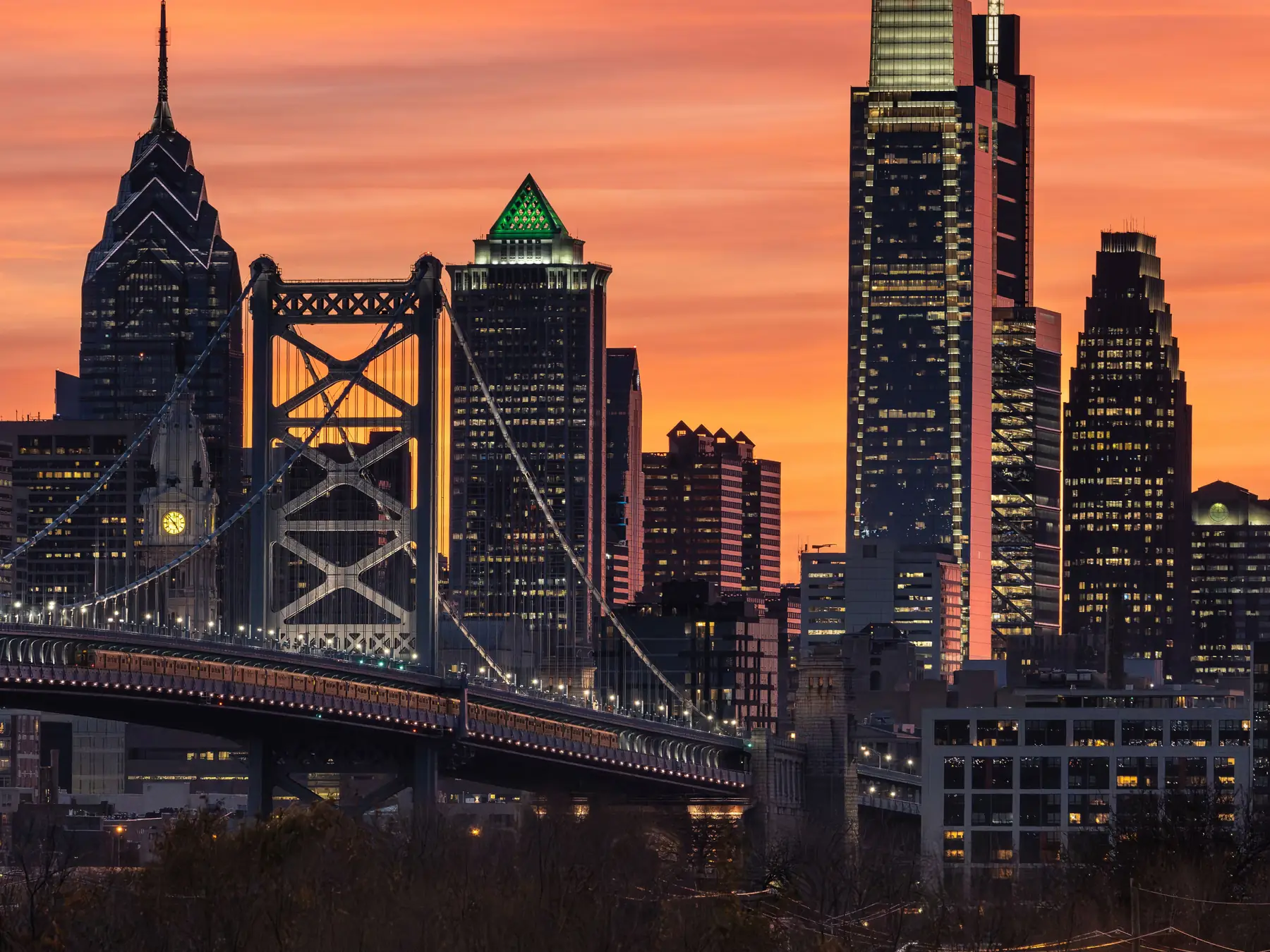 Philadelphia skyline and Benjamin Franklin Bridge at sunset