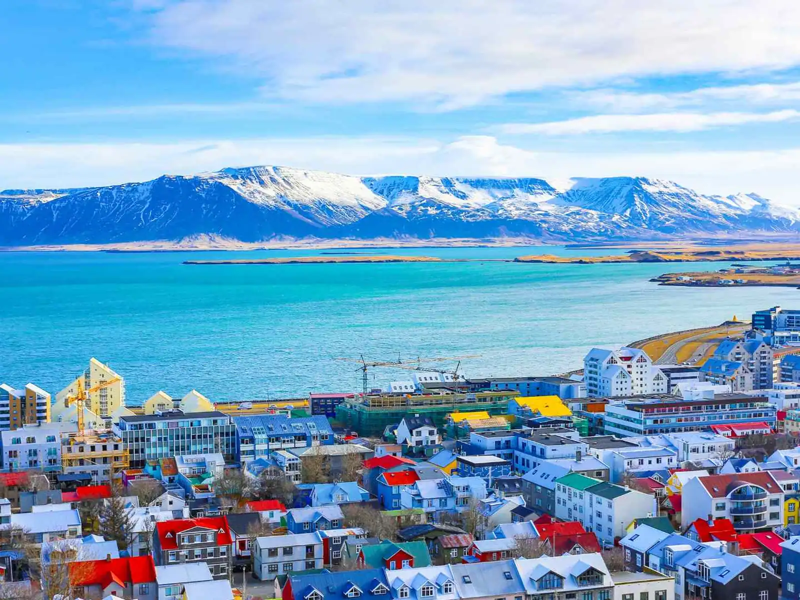 Colorful Reykjavik waterfront with mountains across the bay