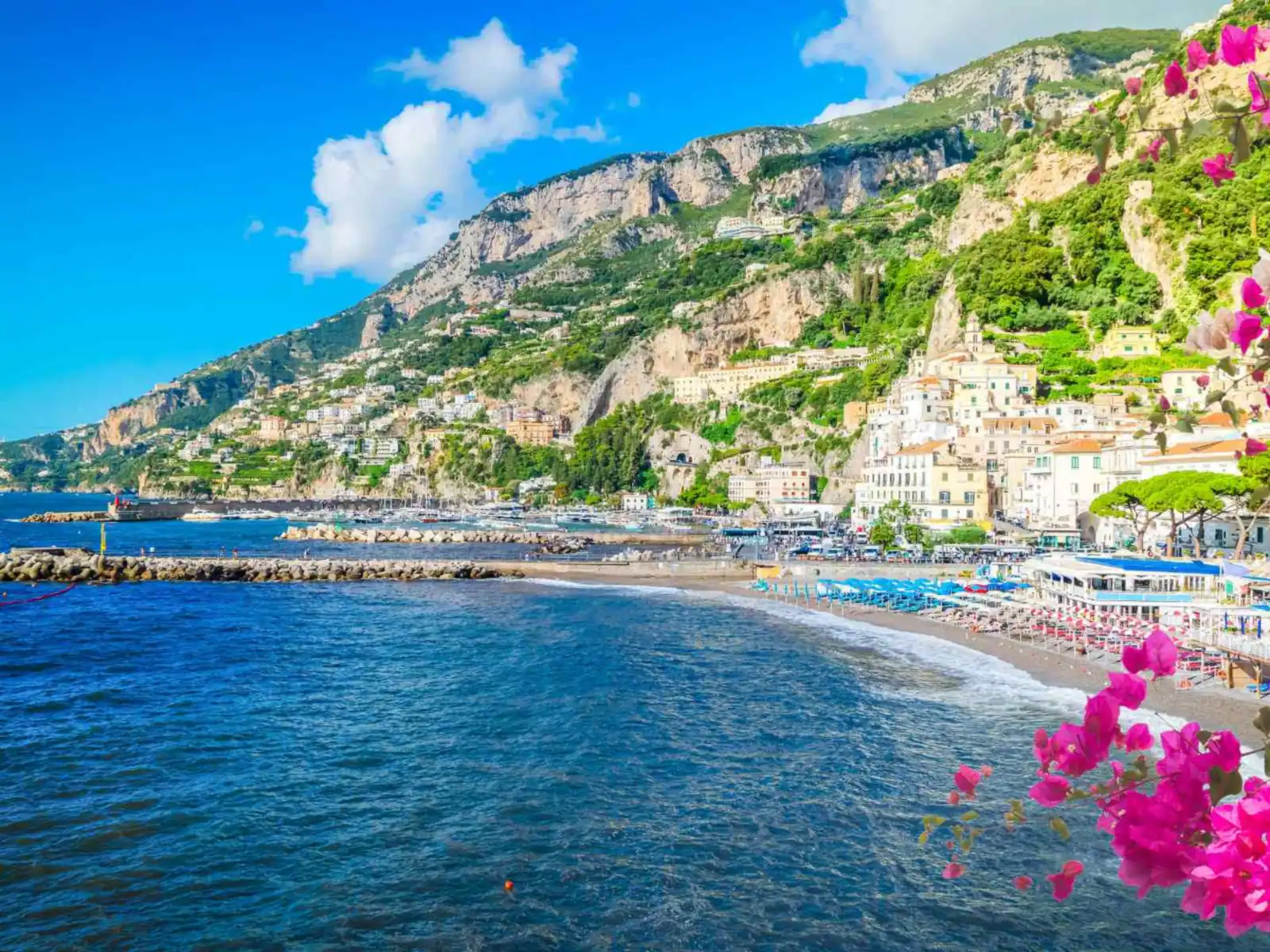Amalfi town and coastline framed by bright bougainvillea