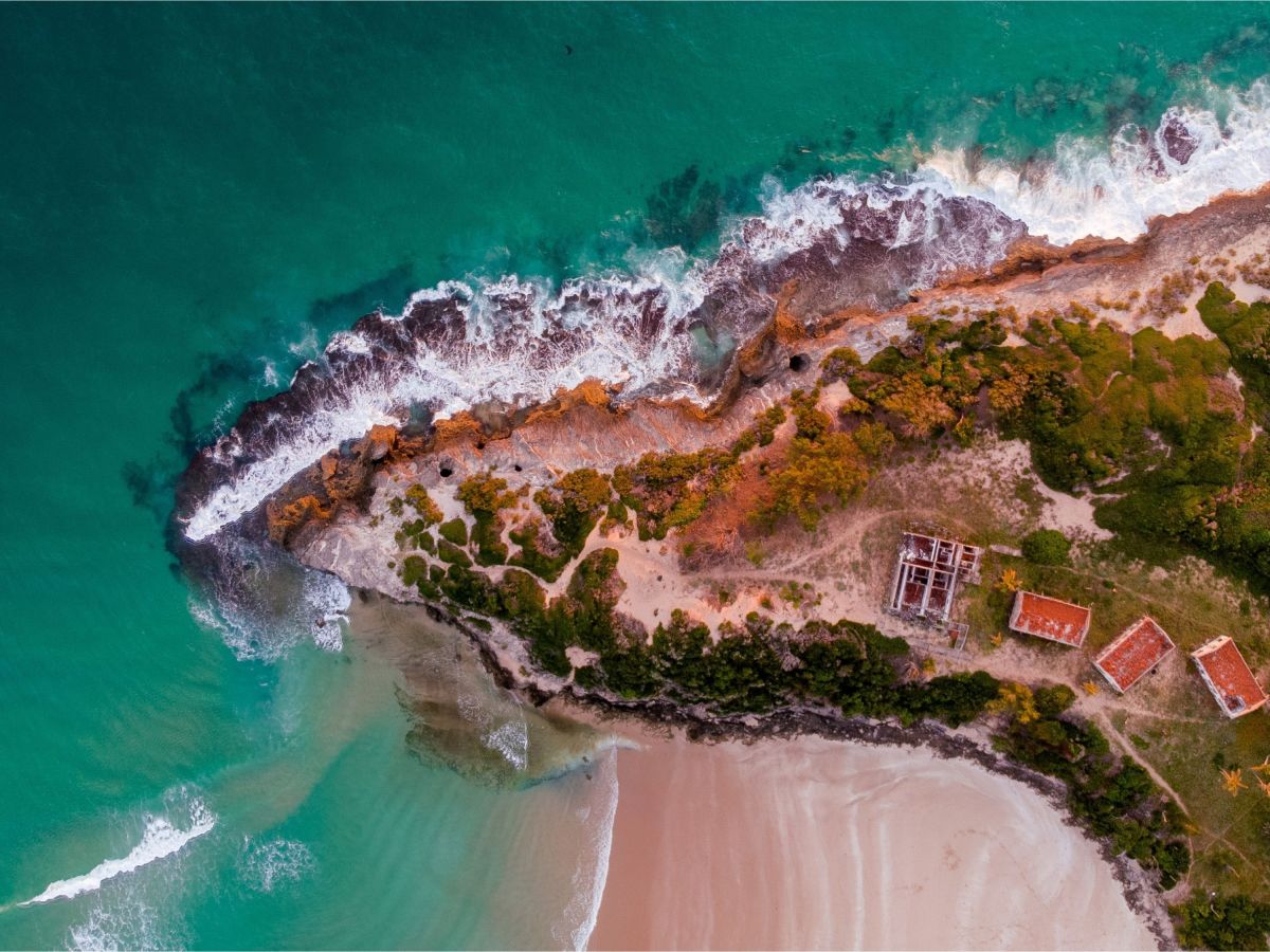 Aerial view of the narrow Pomene coastline and turquoise water in Mozambique