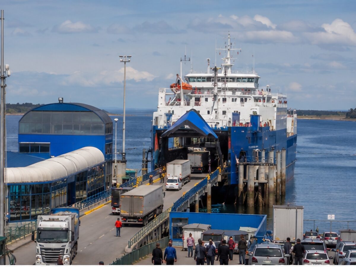 Vehicles and passengers boarding a working ferry at a Chilean terminal