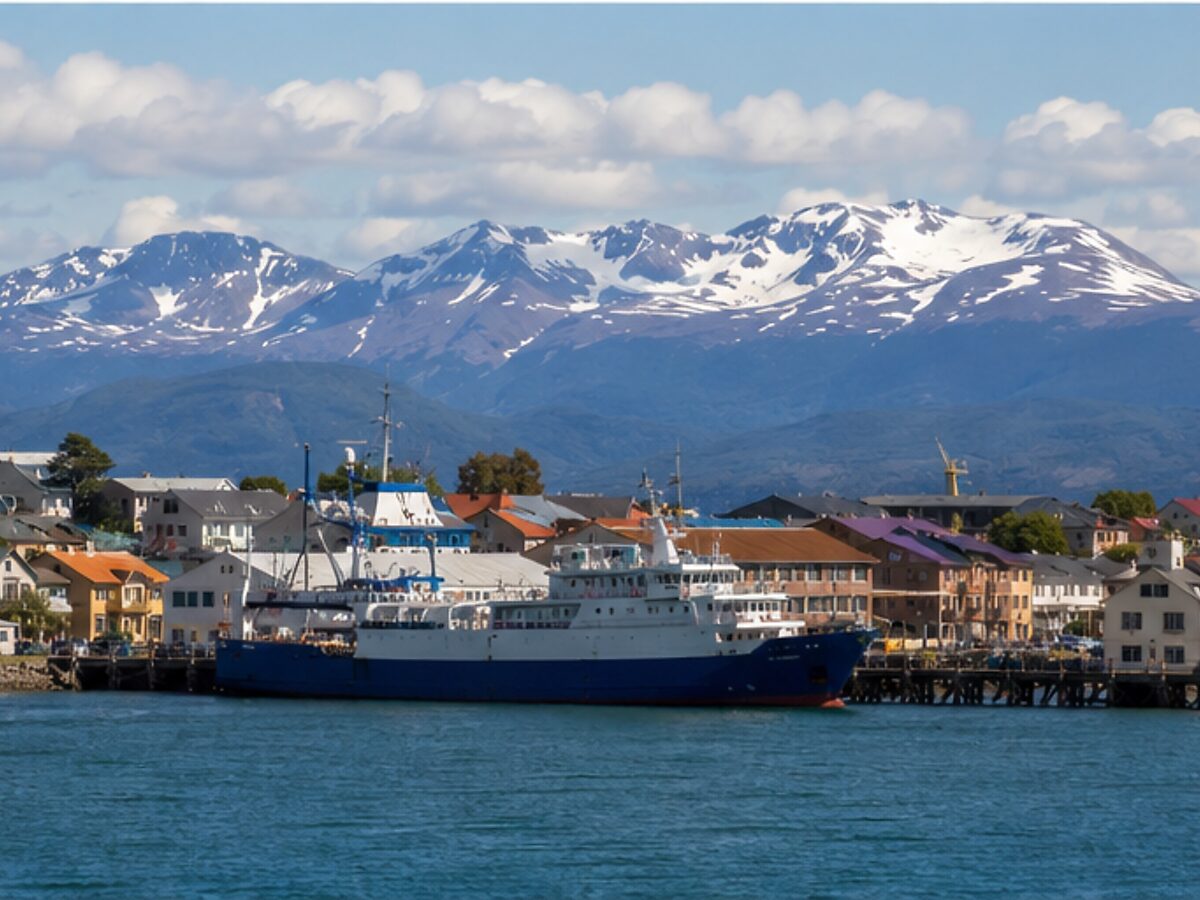 Ferry at the Puerto Natales waterfront with Patagonian mountains behind
