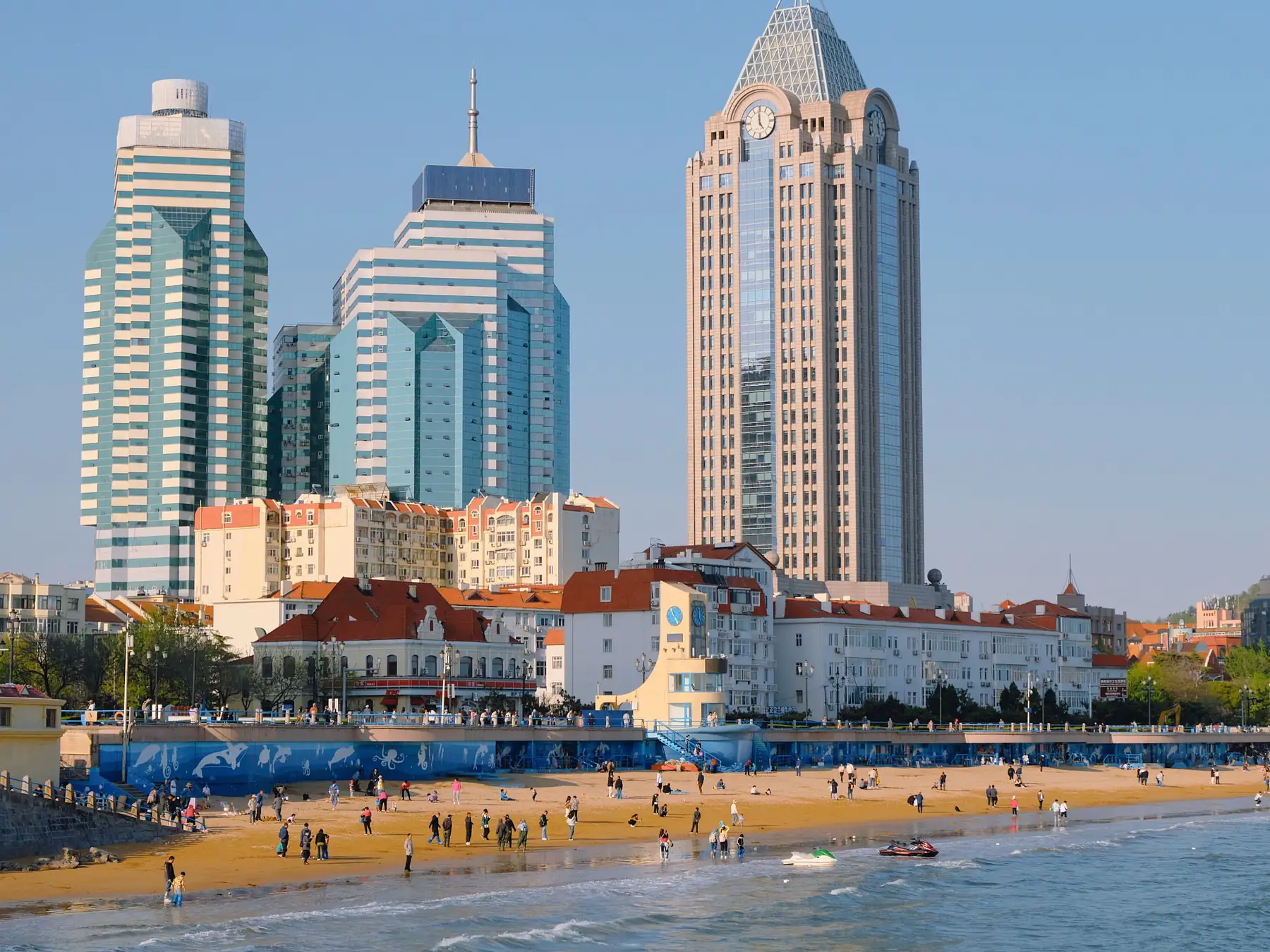 Qingdao beachfront and waterfront skyscrapers under a blue sky