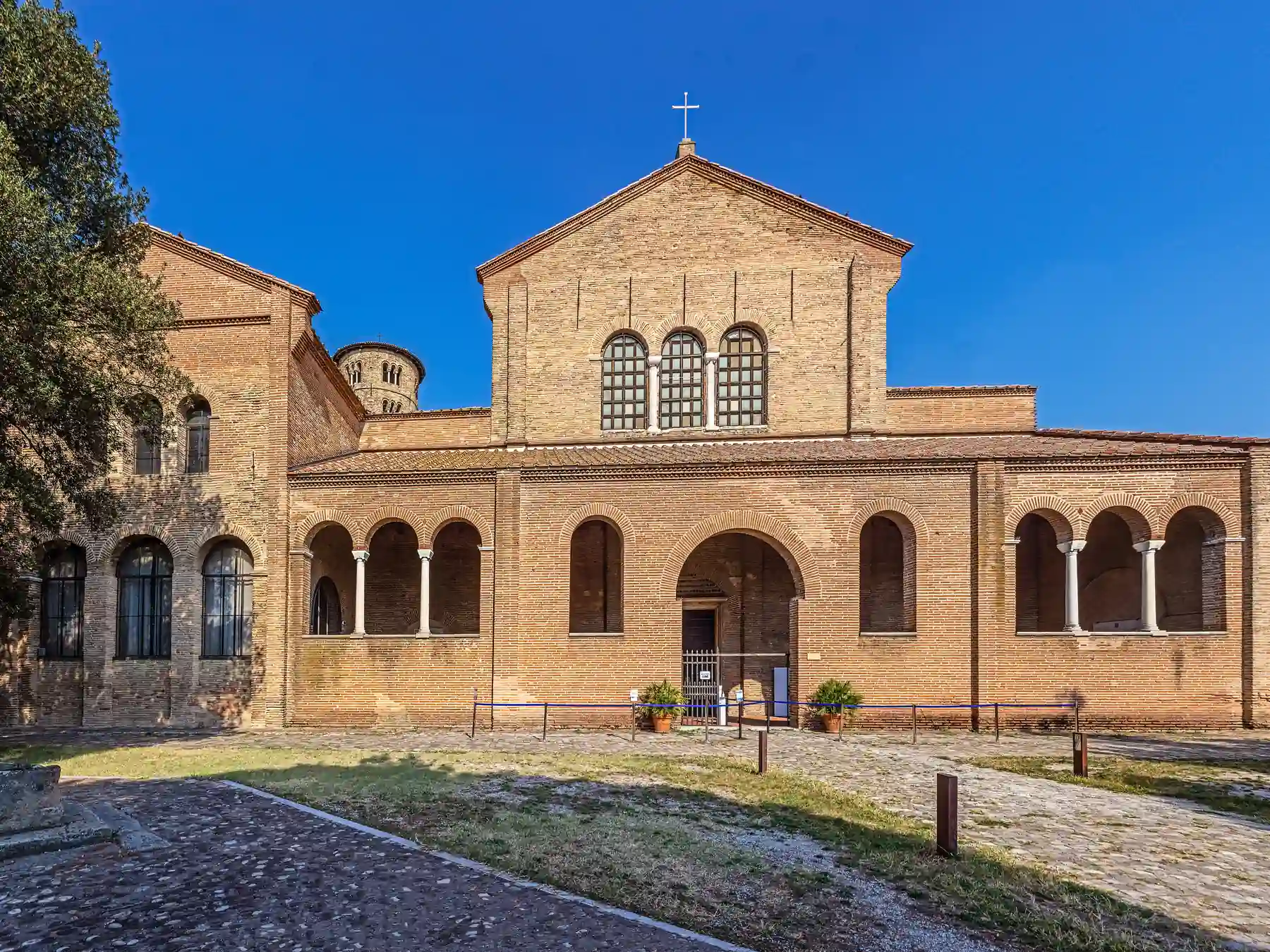 Historic brick exterior and bell tower of the Basilica of Sant'Apollinare in Classe near Ravenna.