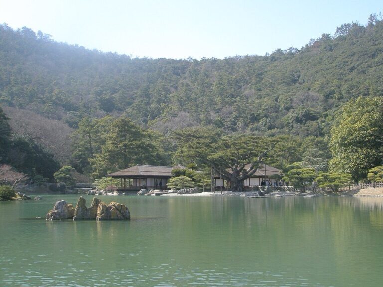 Traditional pavilion beside a green pond in Ritsurin Garden, Takamatsu