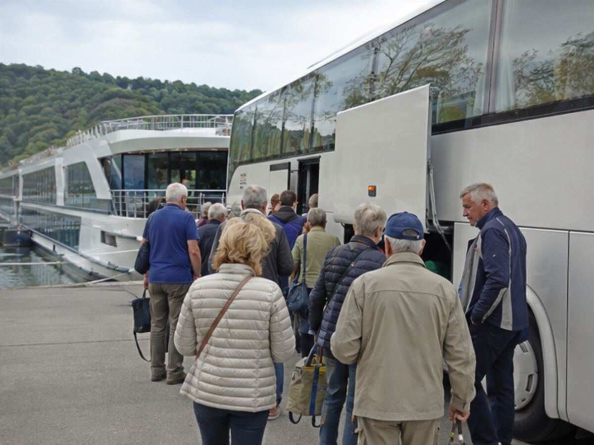 River cruise guests boarding a coach beside a ship during an itinerary transfer