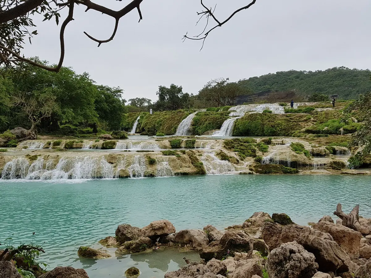 Terraced waterfalls and turquoise pool at Wadi Darbat near Salalah