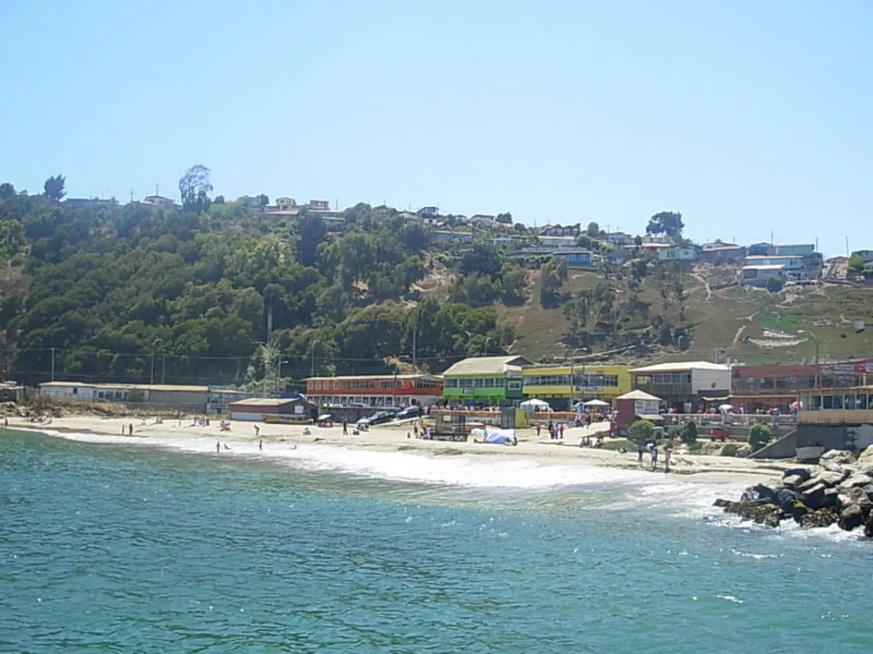 San Antonio's beach and hillside waterfront beside the Pacific Ocean.